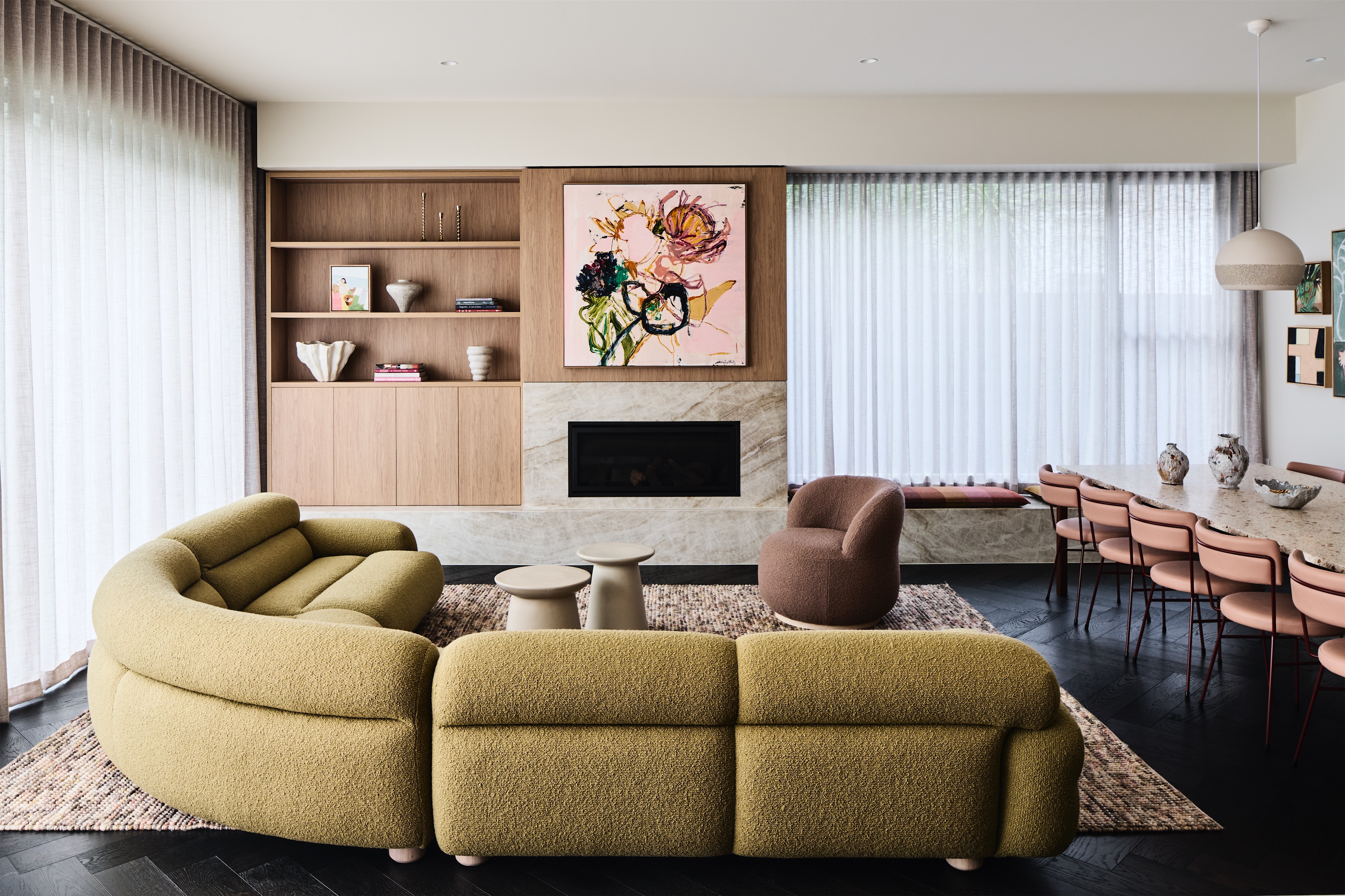 living room with curved olive boucle sofa, timber shelving and stone fireplace, opus 5, caulfield north