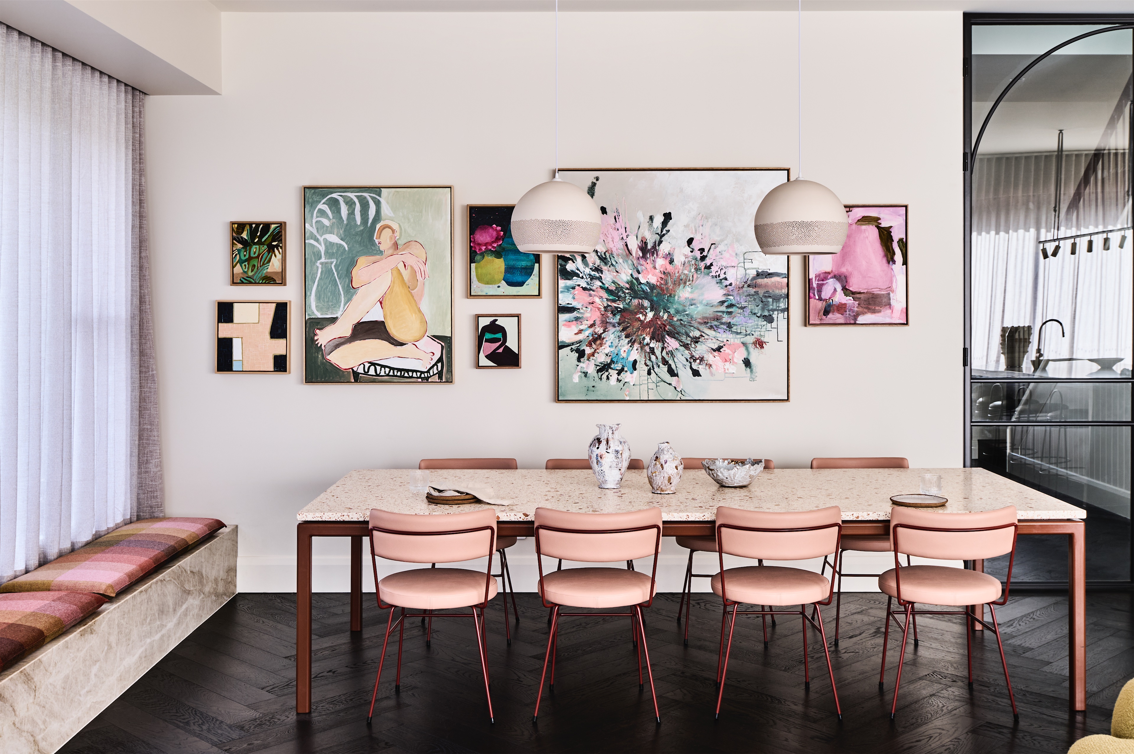 dining room with terrazzo-topped table, pink chairs, gallery wall and stone window seat, opus 5, caulfield north