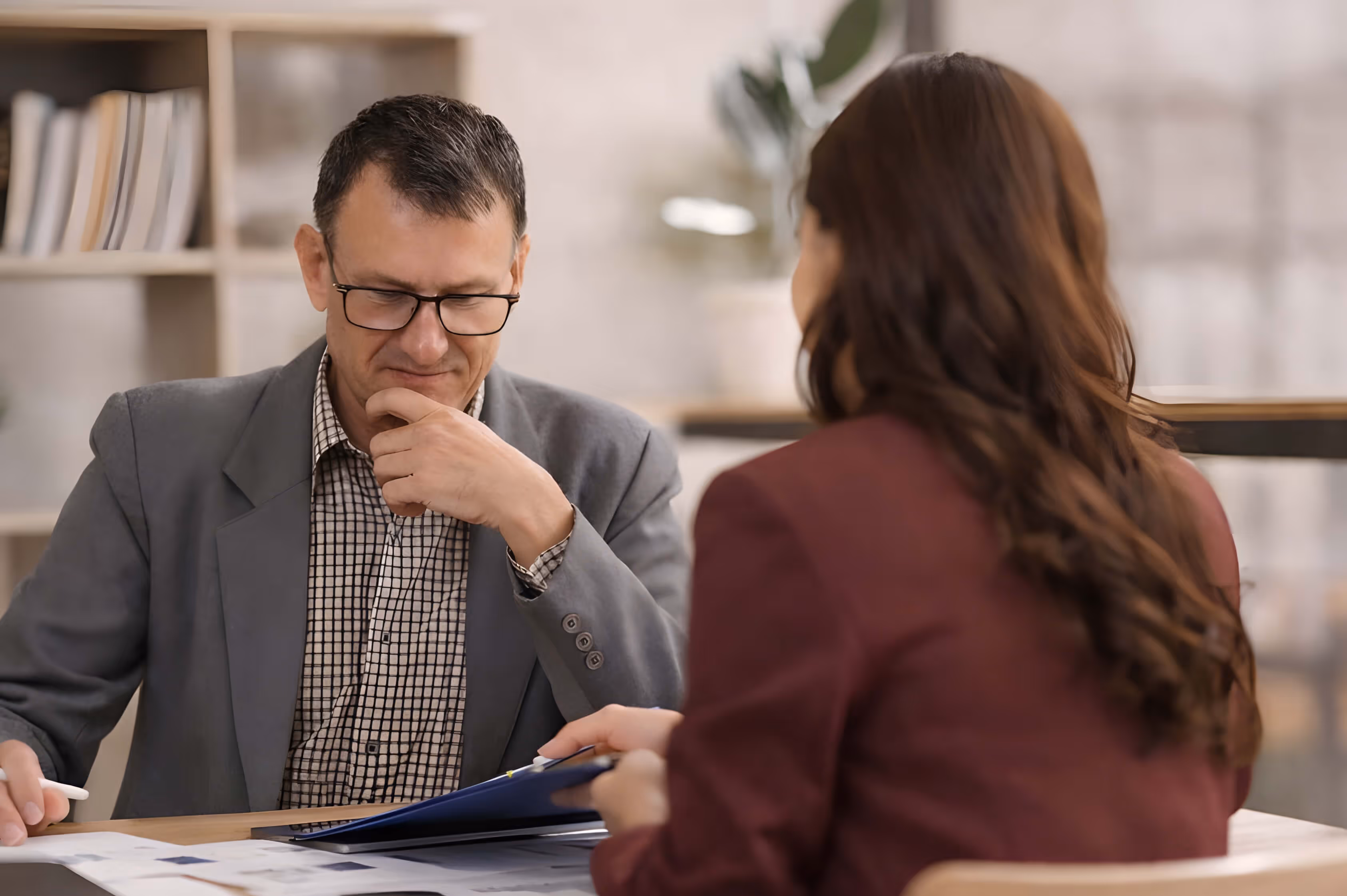 Jewelry consultant reviewing diamond grading report with a client