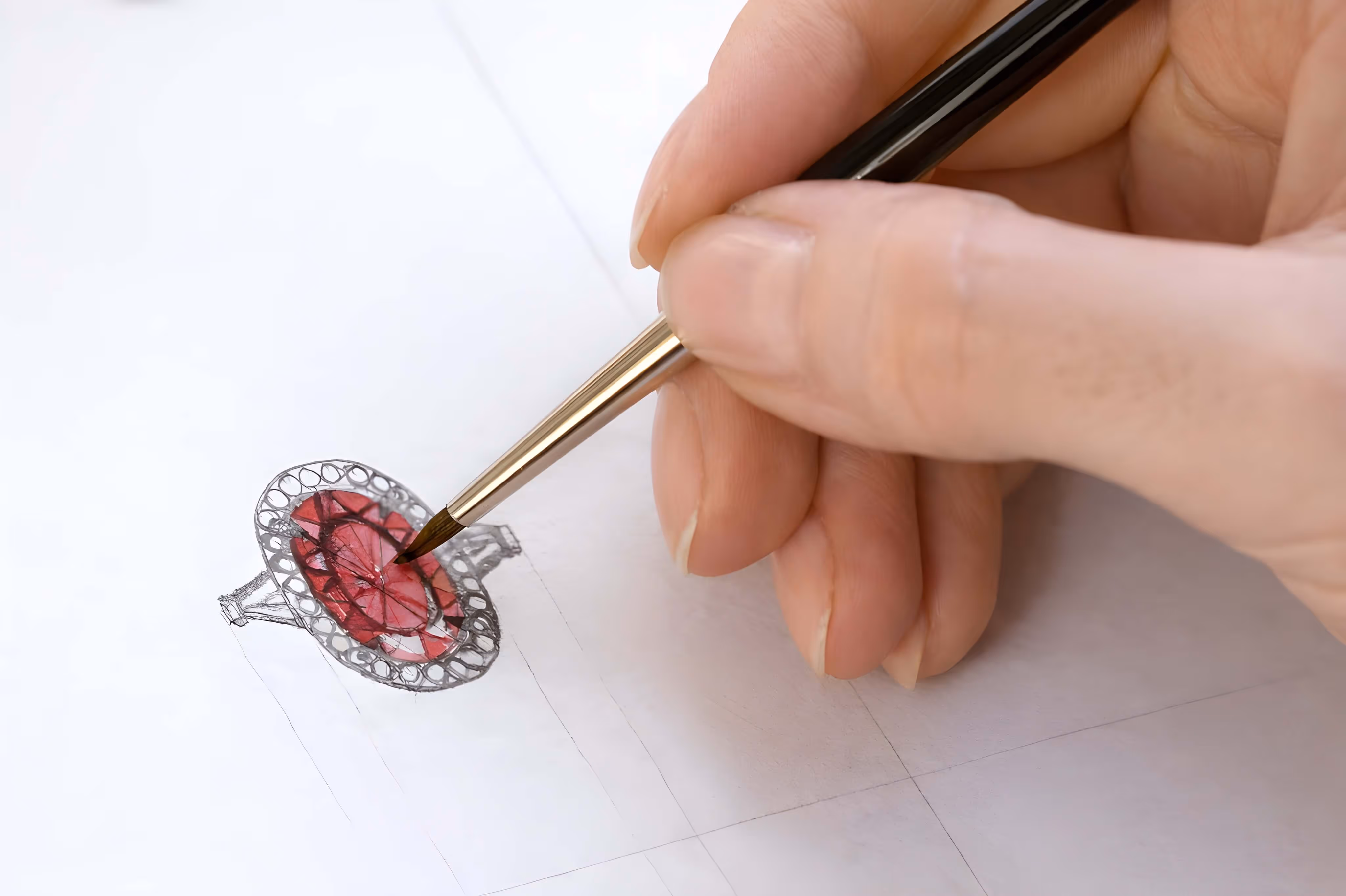 Sketching a custom engagement ring design with a red gemstone