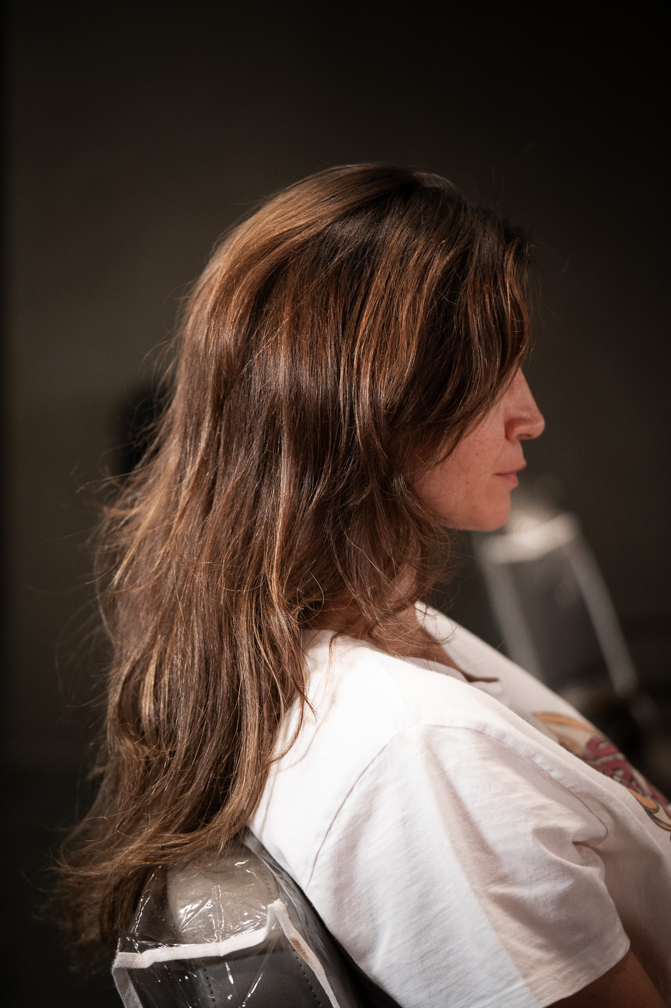 Side profile of glossy, light-reflective hair styled at March14 Hair Studio Dubai