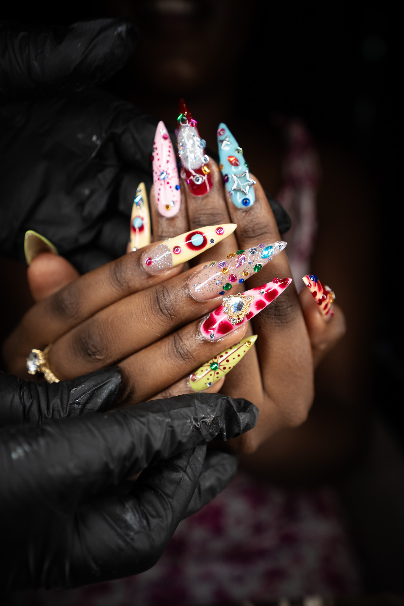 Nail artist at March14 Nails Theatre finishing whimsy maxxing nail art in Dubai