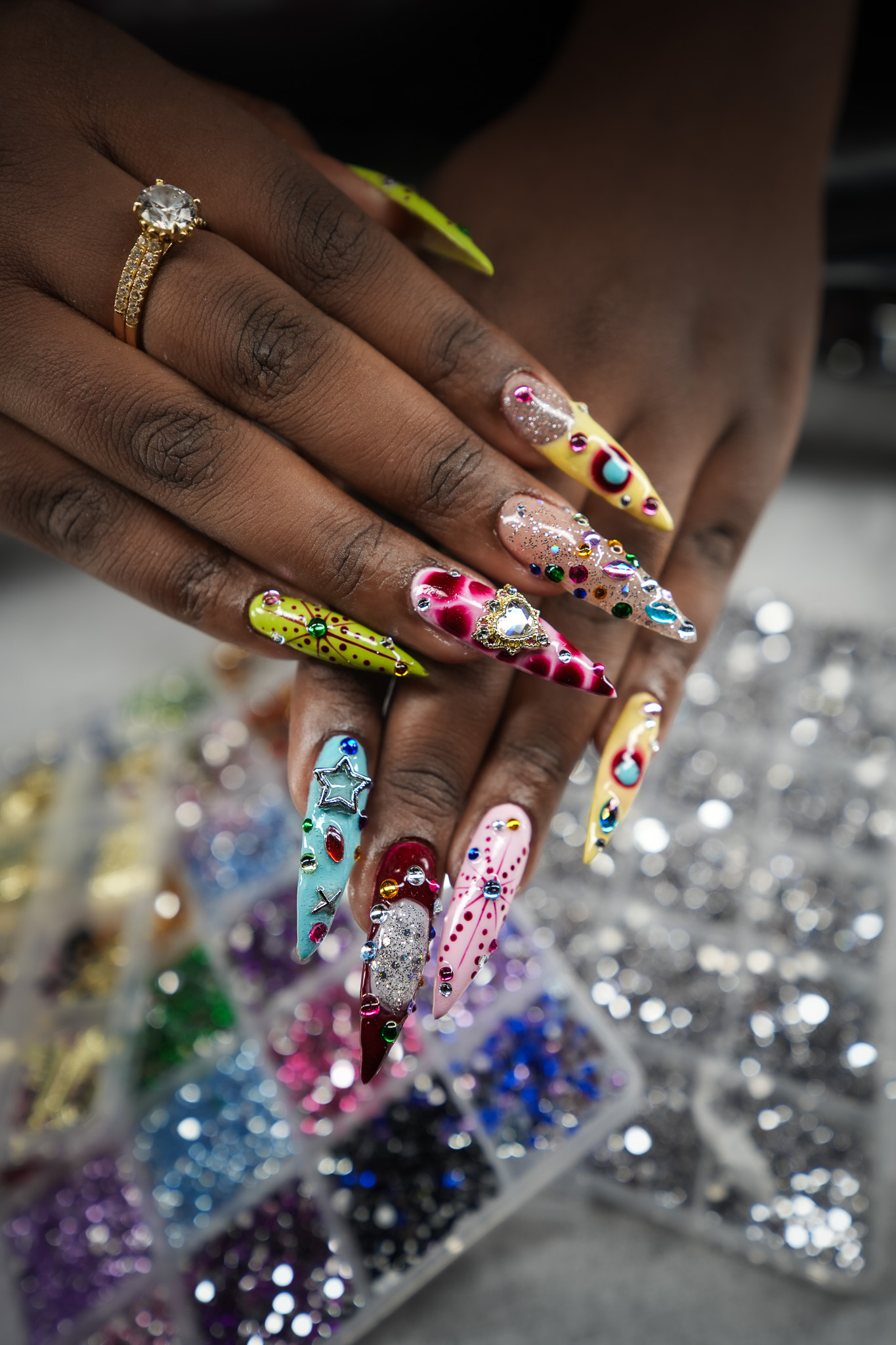 Close up of rhinestones and charms used in March14 whimsy maxxing nail art Dubai