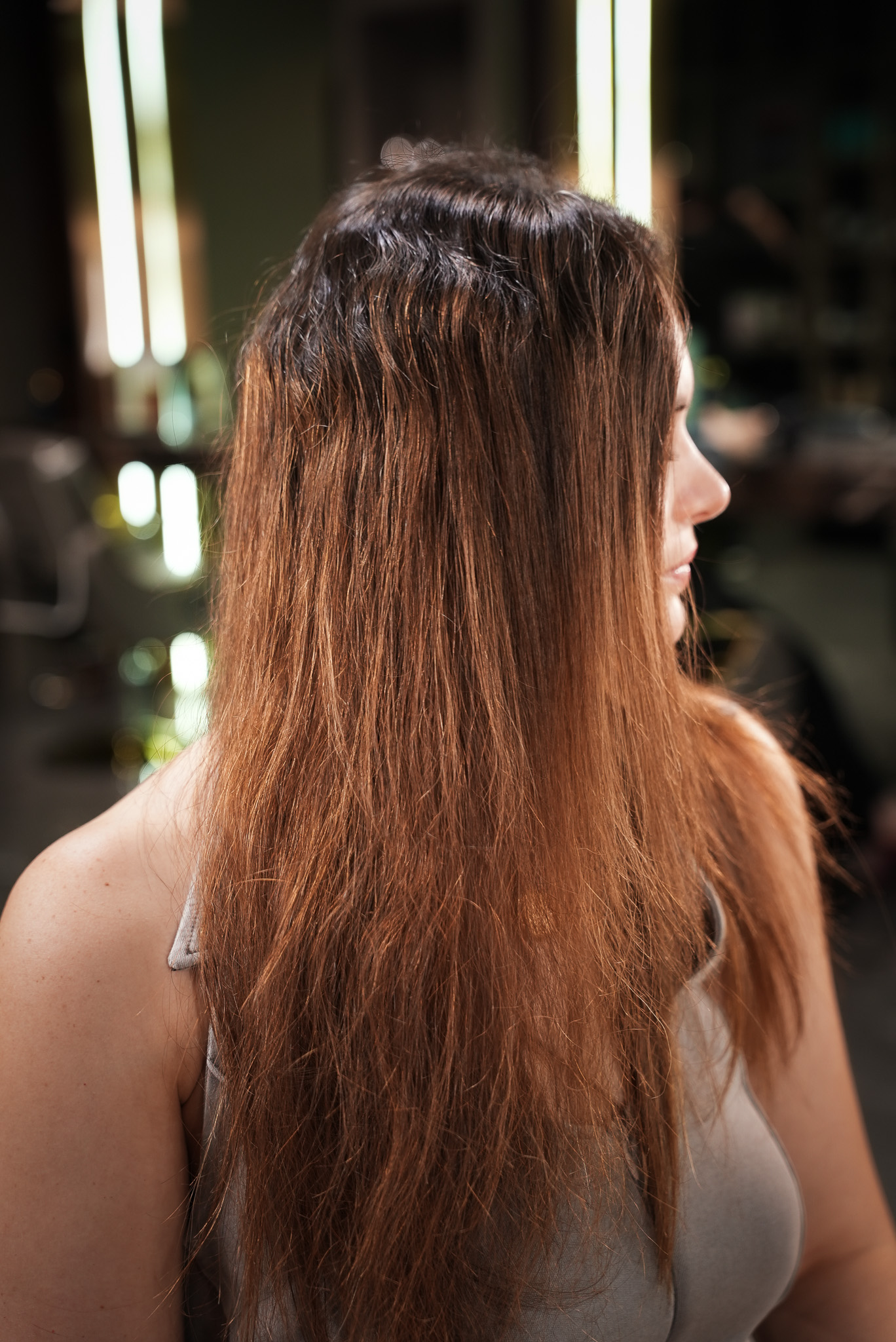 Before: back view of faded copper hair before blonde highlights at March14 Dubai