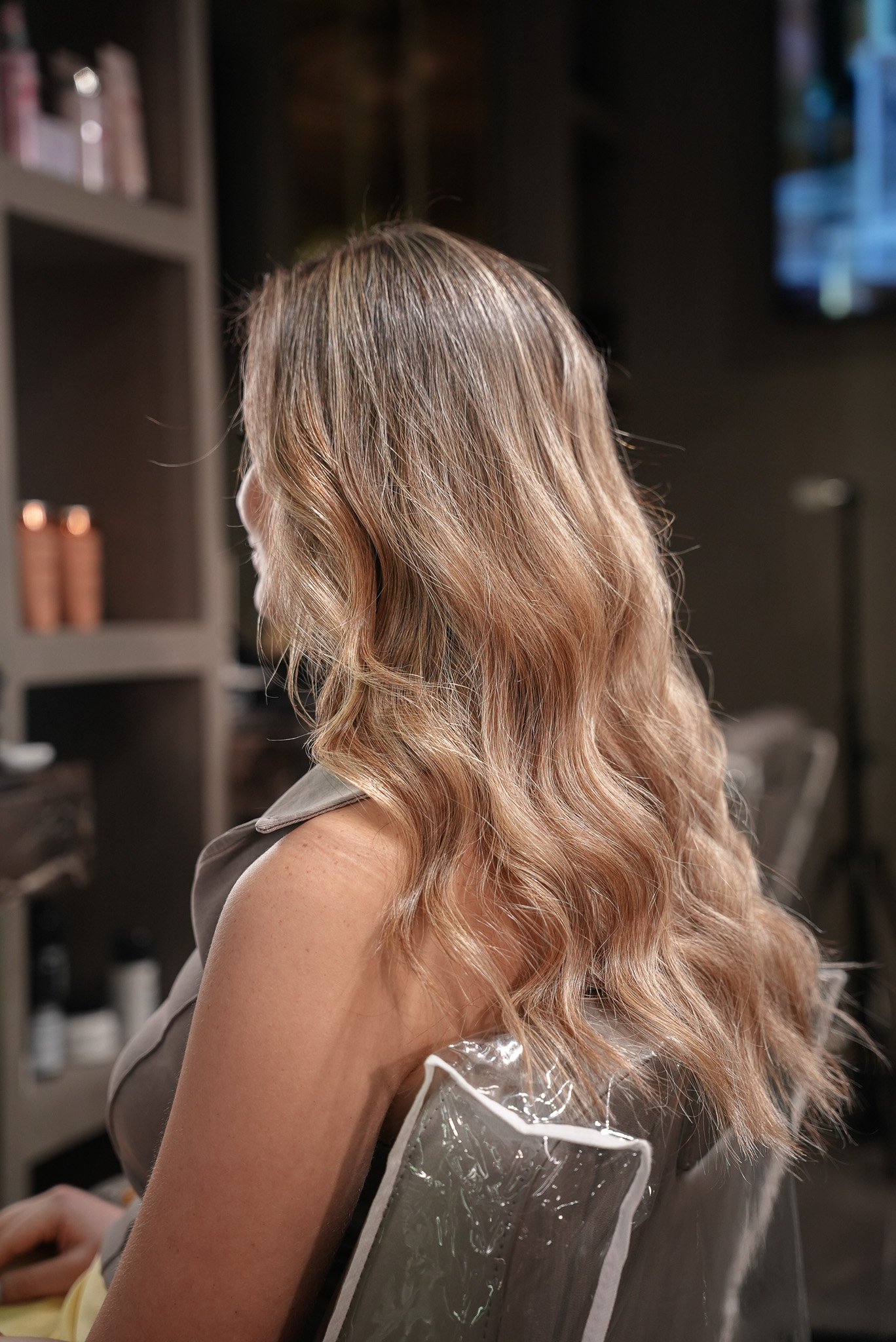 After: soft beige blonde highlights with waves at March14, best blonde highlights salon in Dubai