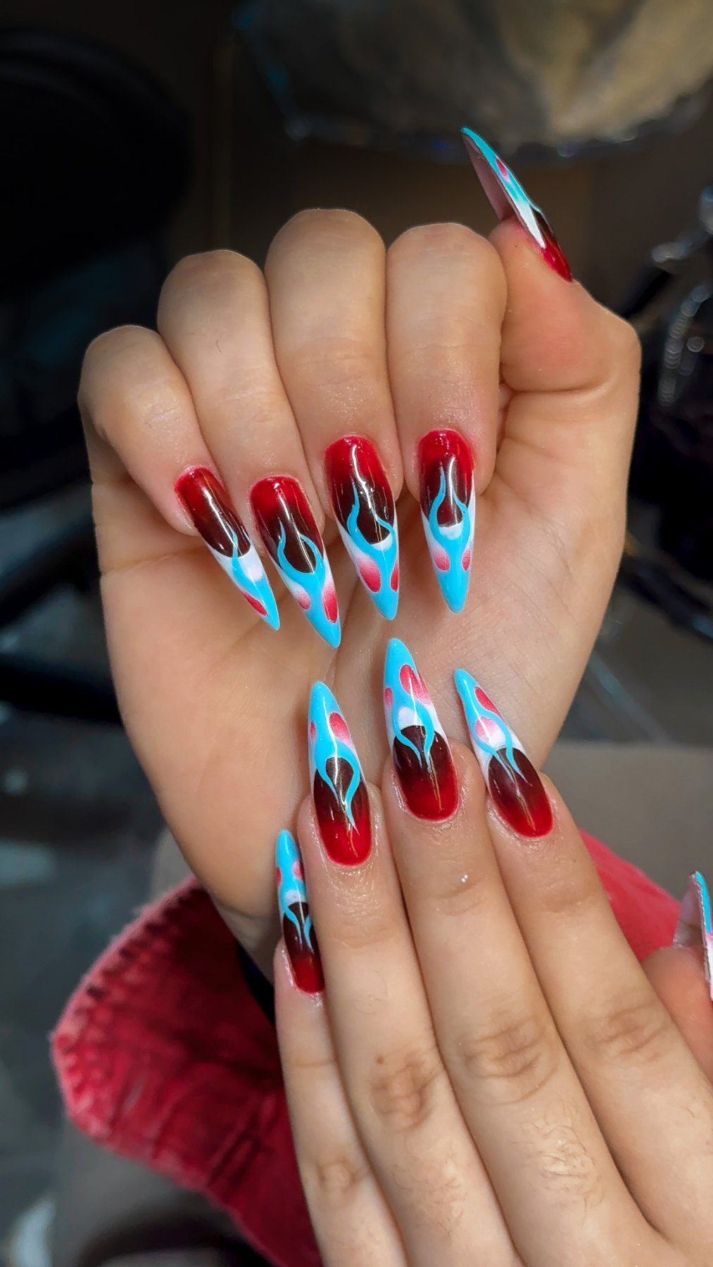 Blue flame nail art on cherry red ombré stiletto nails, best salon for nail art in Dubai March14