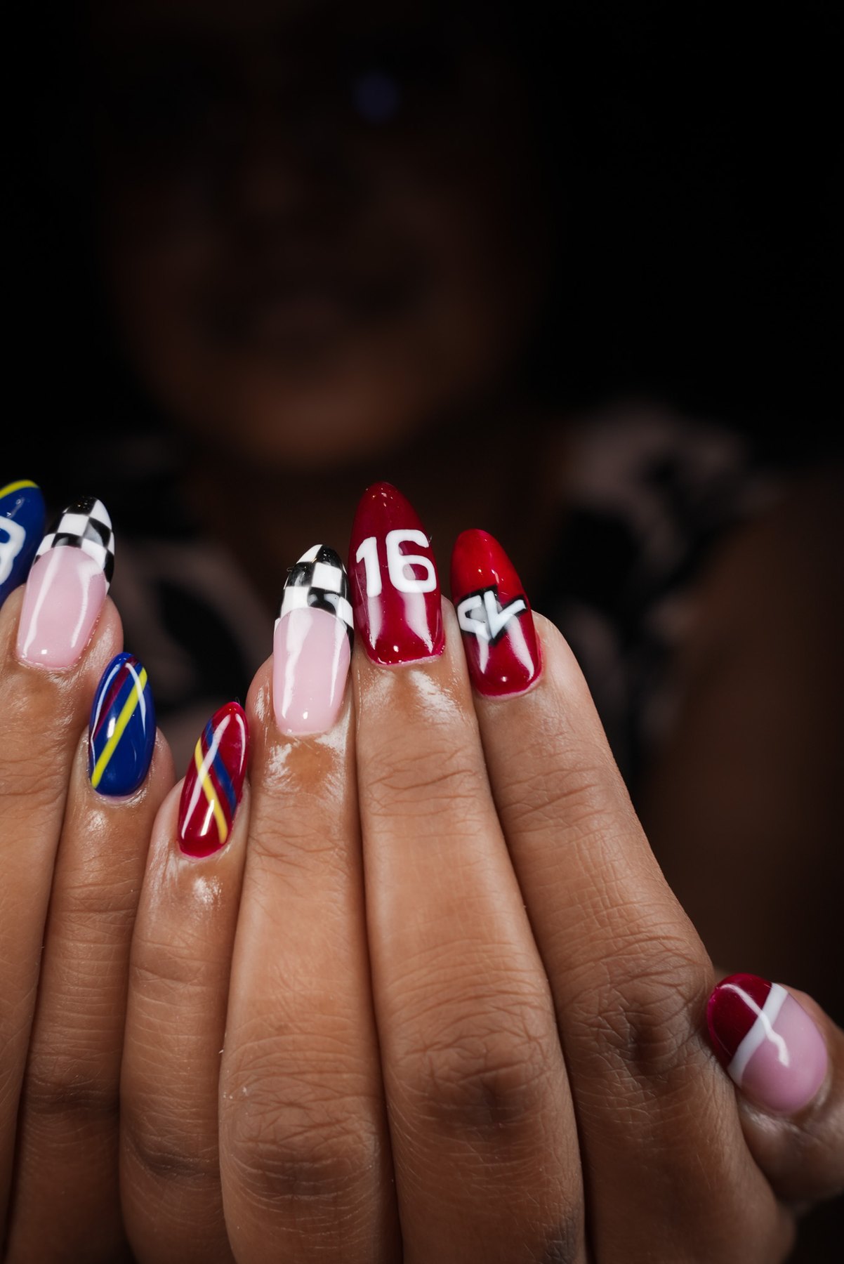 Charles Leclerc number 16 F1 nails in burgundy and a chequered French tip, best nail art in Dubai at March14