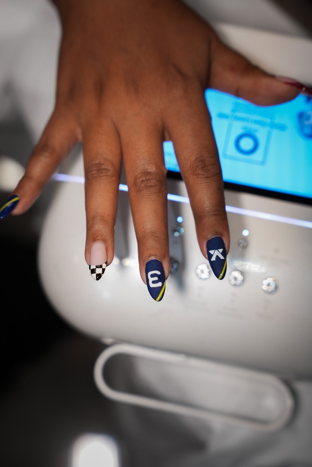 Navy F1 nail art in Dubai at the satin stage before top coat, with race number 3, emblem and chequered tip
