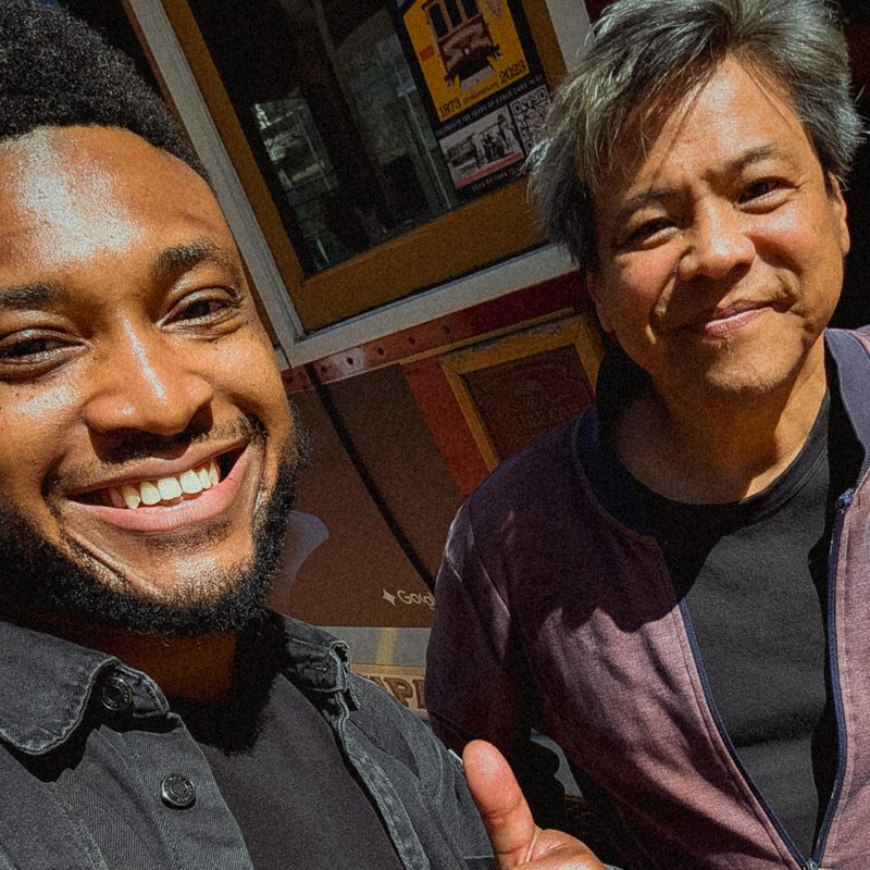 Nathan Marshall and Ron Shigeta smiling together in front of a San Francisco cable car.