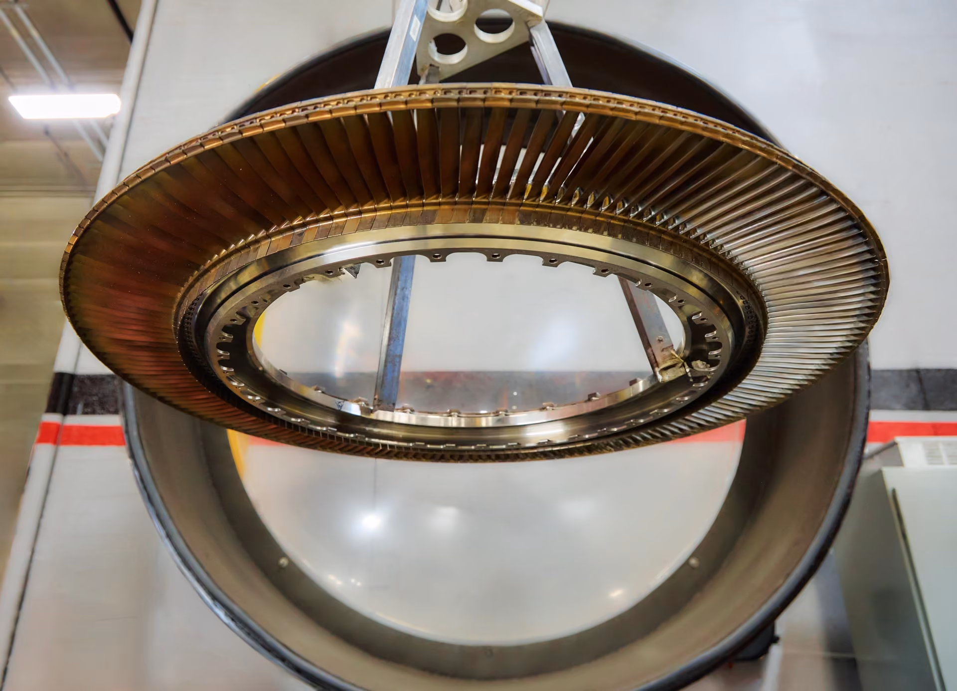 Close-up of a turbine engine blade assembly suspended inside a workshop of the company named Advanced Turbine Systems LLC