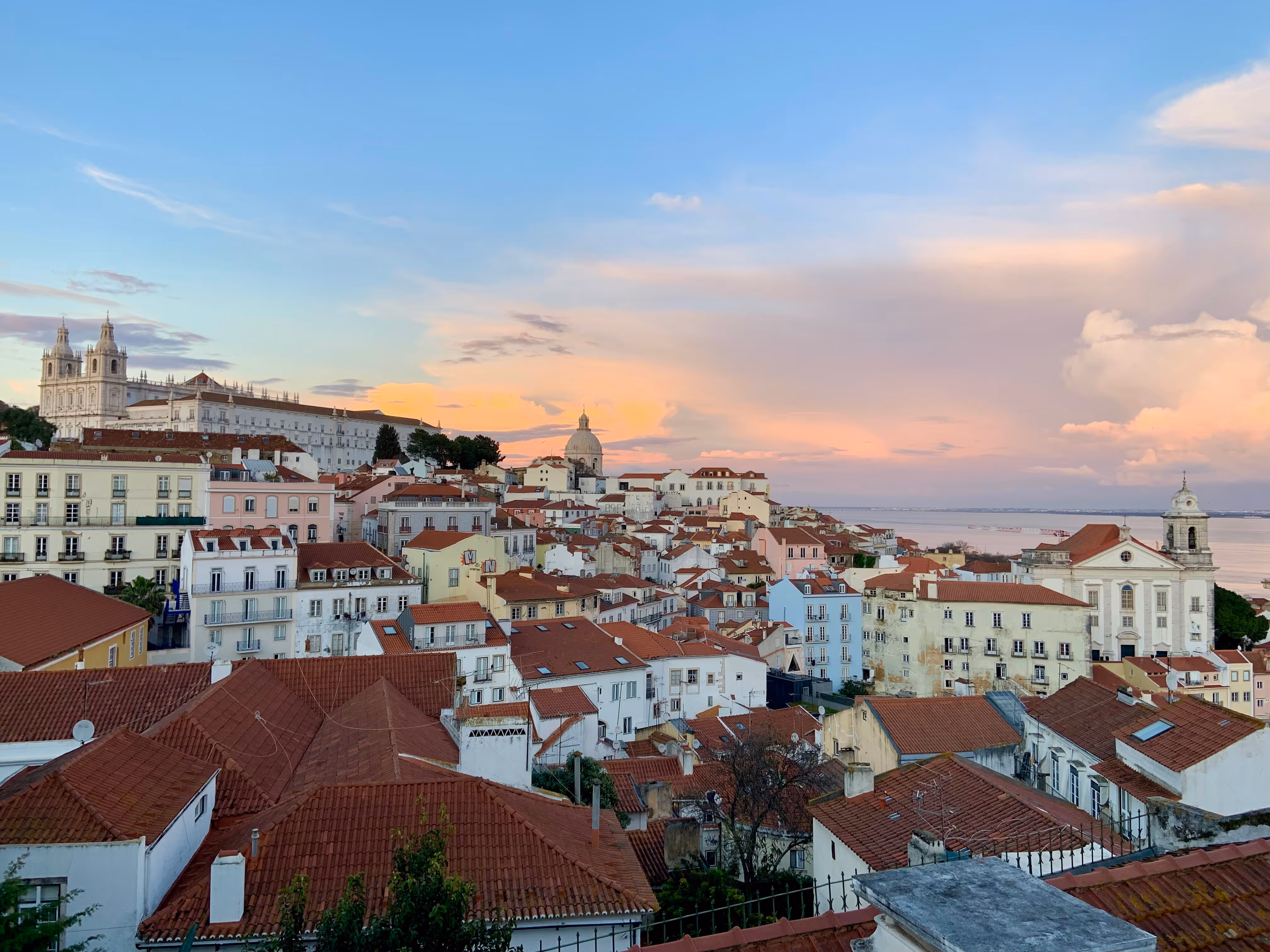 Red rooftops at sunset in Lisbon, Portugal. 