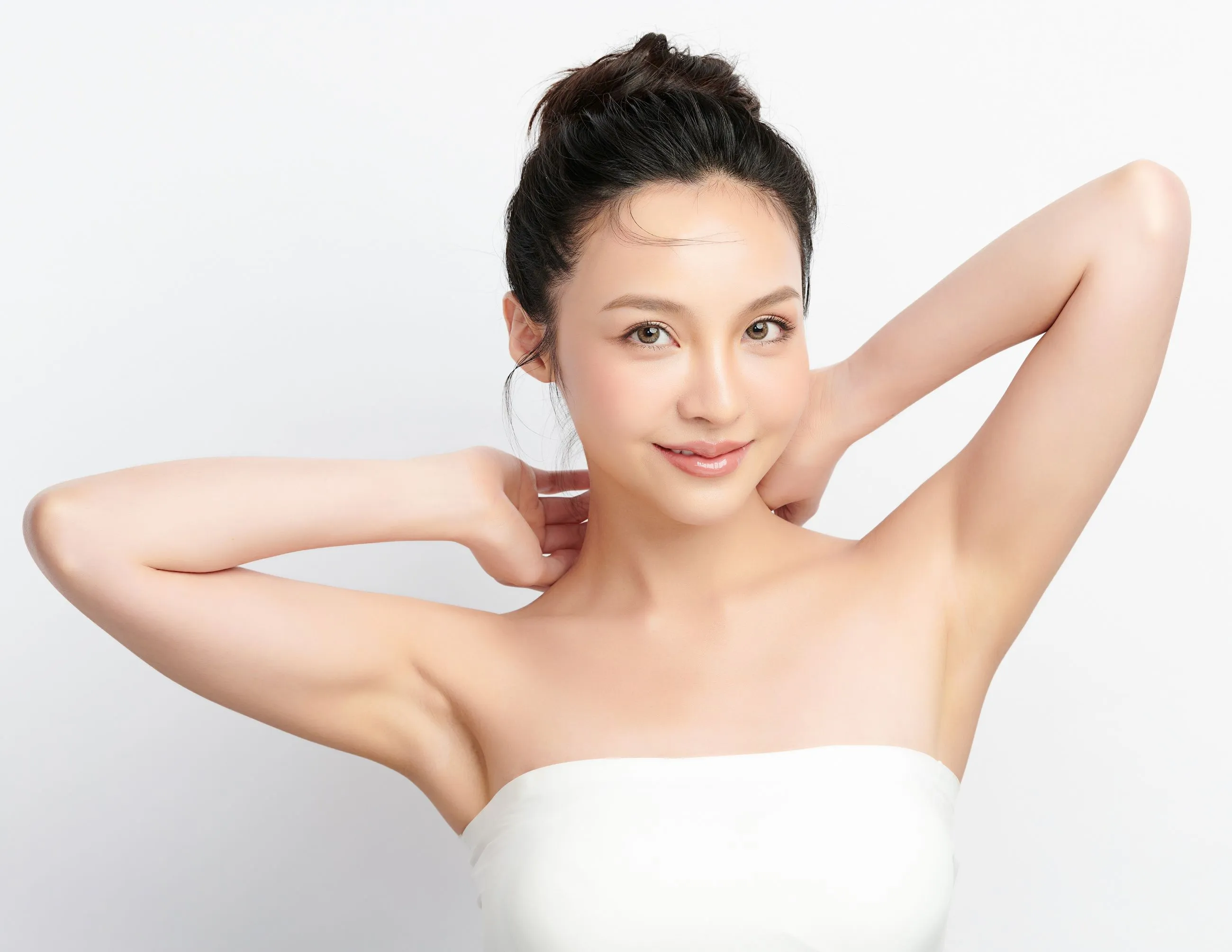 A woman in a white top posing for a picture.