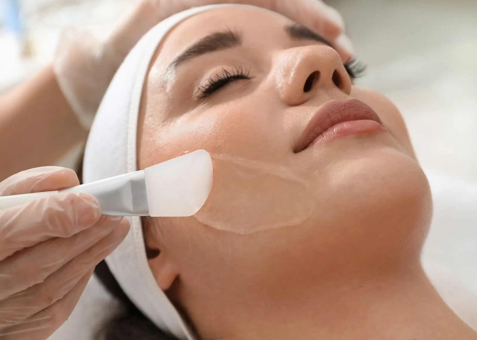 A woman getting a facial peel on her face.