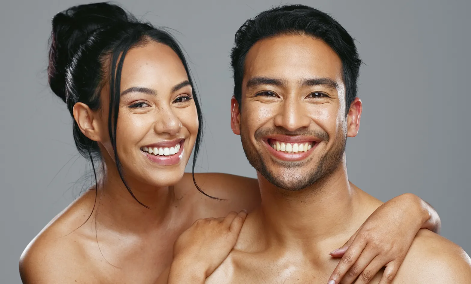 A man and a woman smiling at the camera.