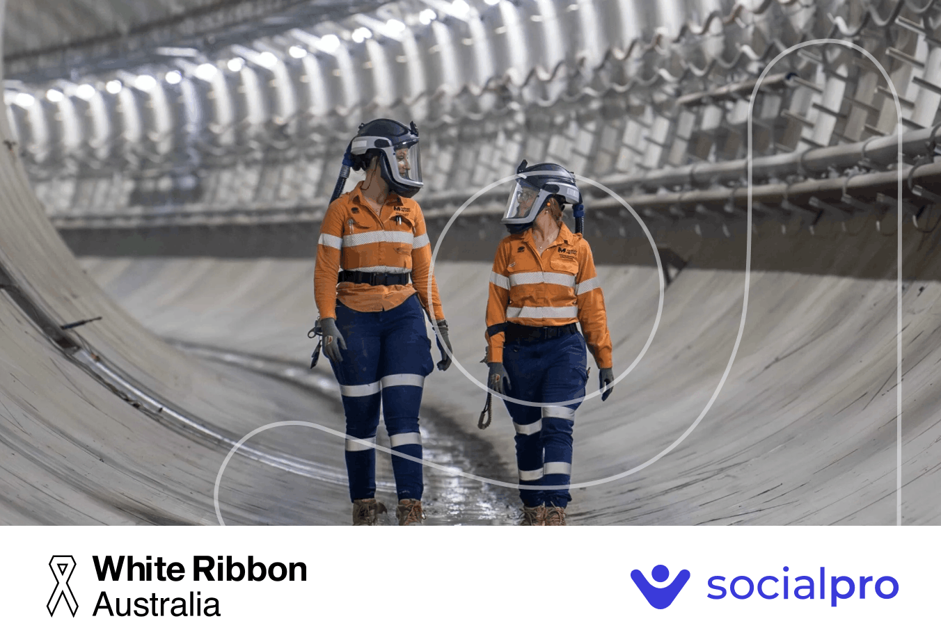 Two workers talking to each other inside a tunnel