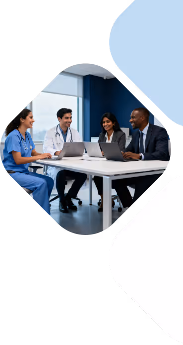 Medical professionals and business colleagues in a meeting around a table with laptops in an office.
