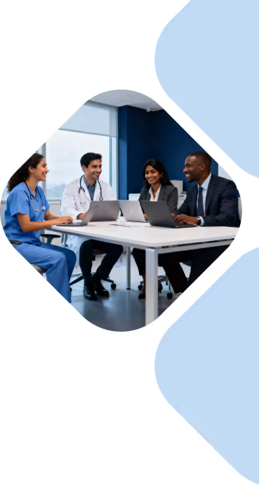 Four diverse professionals, including two doctors, seated around a table with laptops in a modern office.