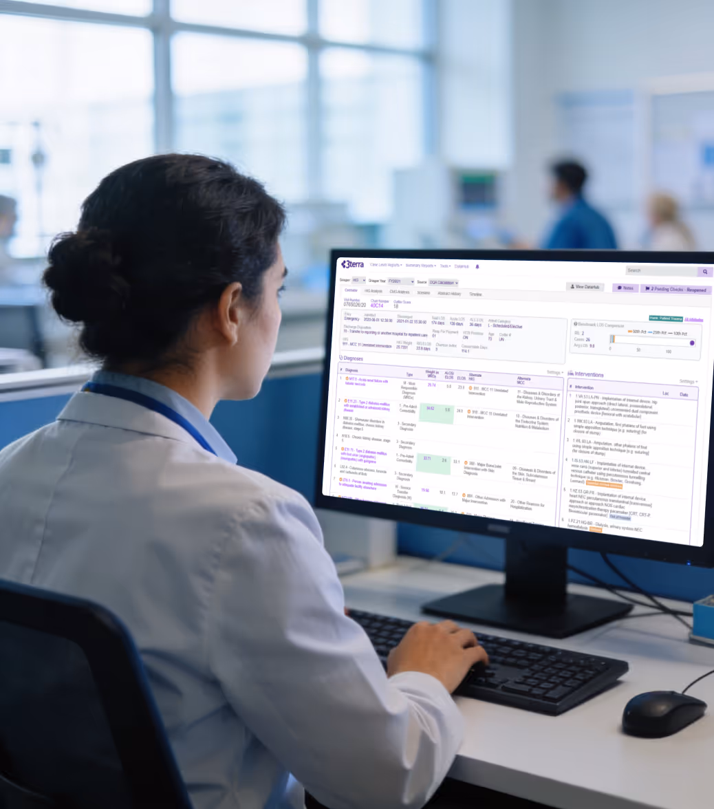 Doctor in a lab coat using a computer showing medical data and patient records on screen.