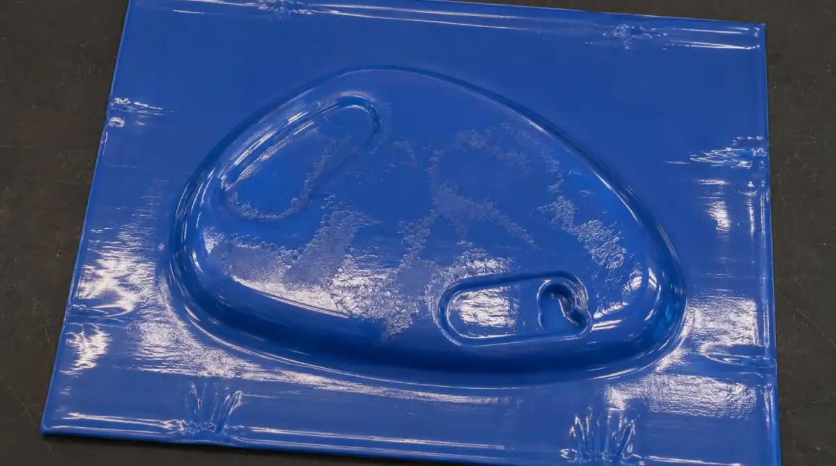 Damaged acrylic sheet with masking residue and surface marks caused by excessive oven temperature during vacuum forming