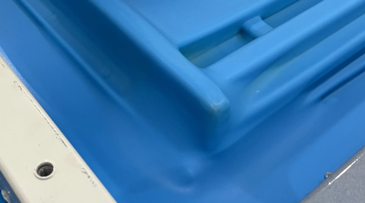 Close-up of thermoformed panel showing poor surface texture reproduction and rounded sharp edges from underheated plastic sheet