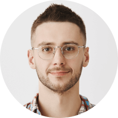 a man wearing glasses and a plaid shirt