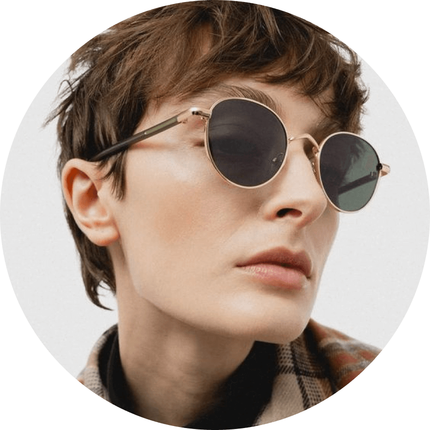A woman wearing sunglasses and a scarf.