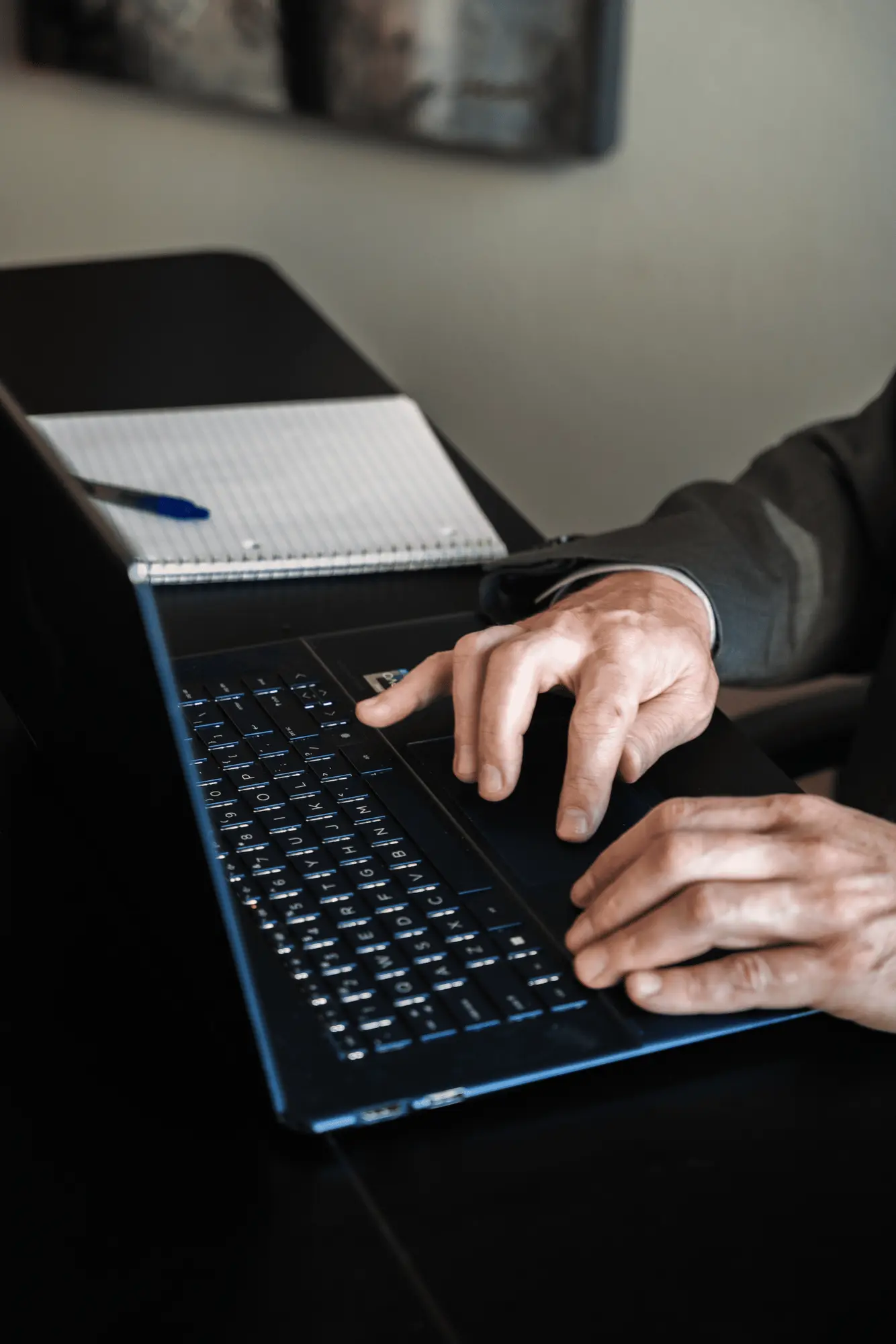 Close-up of an executive working on a laptop during research and analysis.