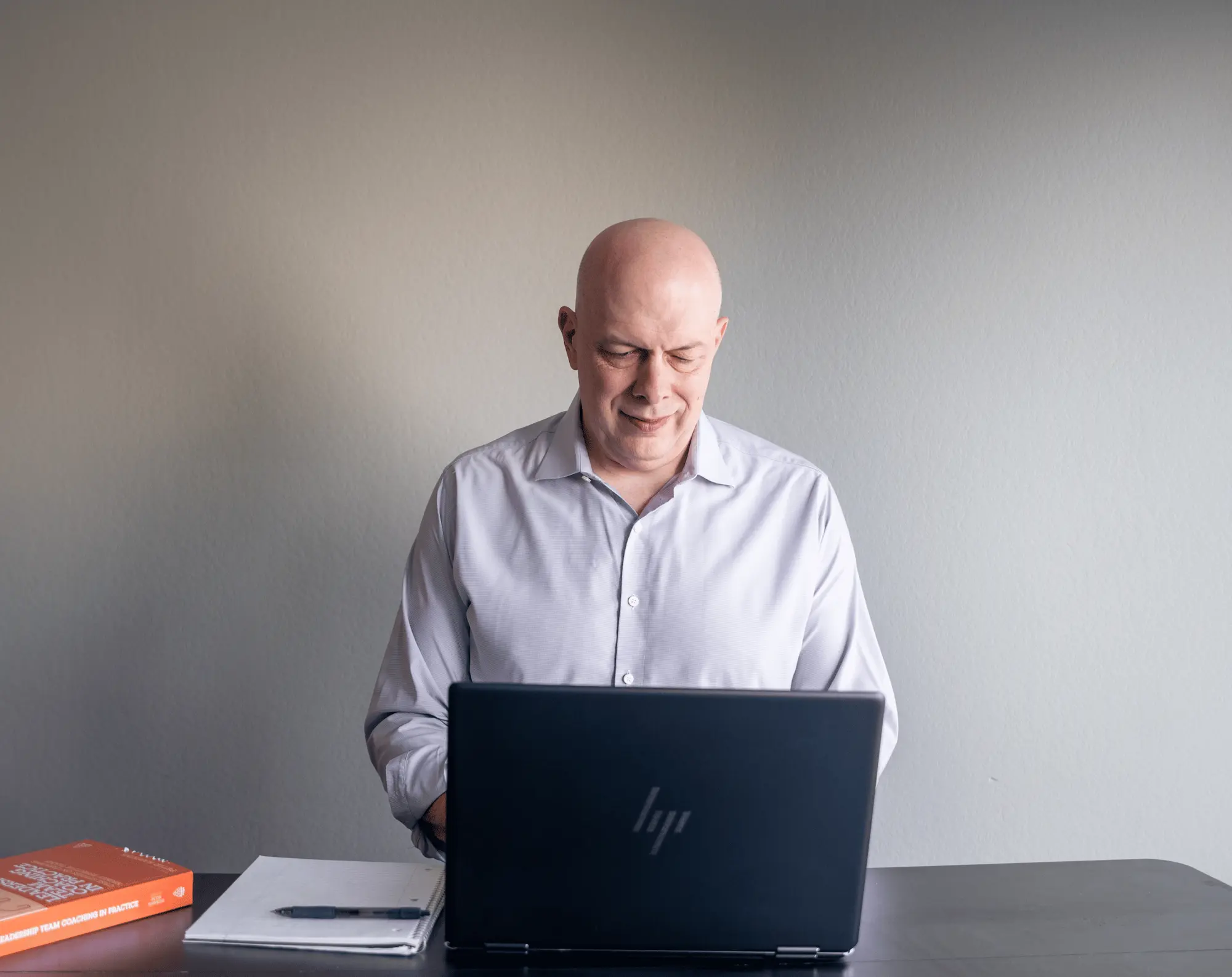 Matthew Johnson working at a laptop during an executive advisory session.