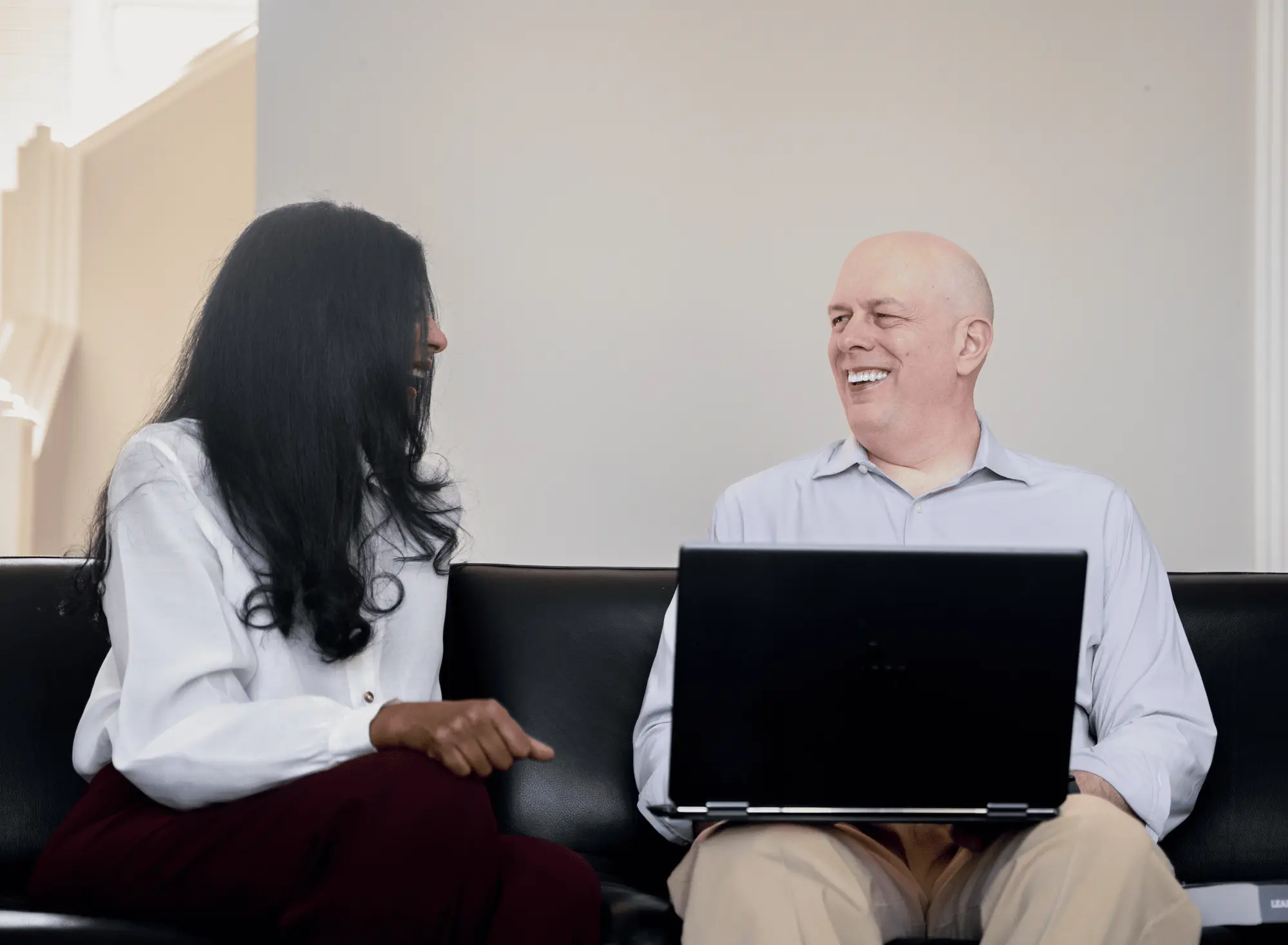 Sandhya and Matthew Johnson collaborating over a laptop.