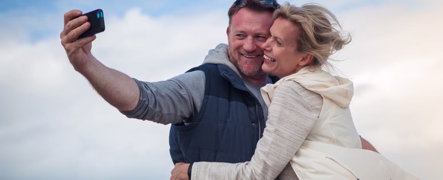 A man and perimenopausal woman smiling