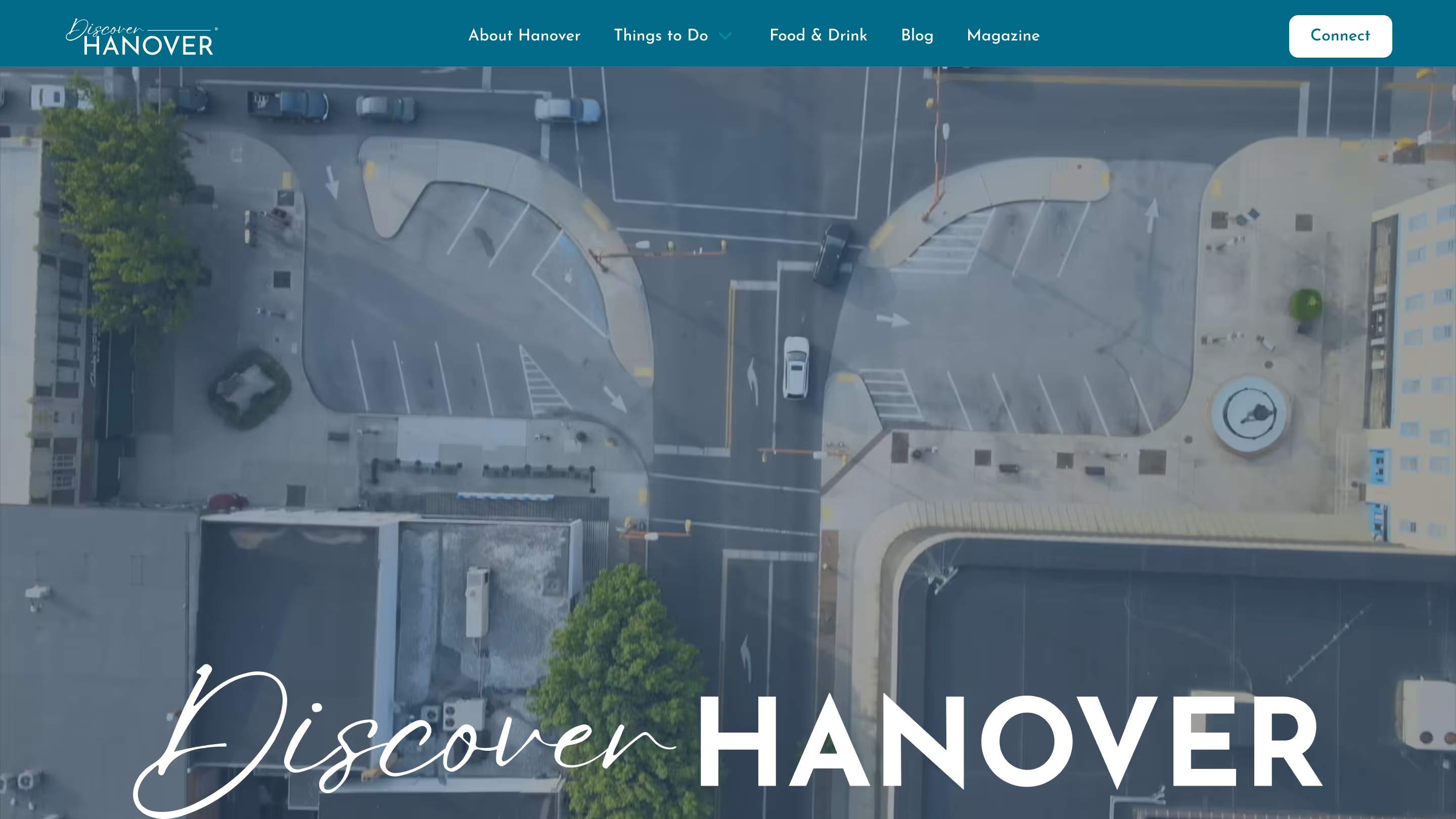 Hero section of the Discover Hanover website featuring a top-down view of the town's square