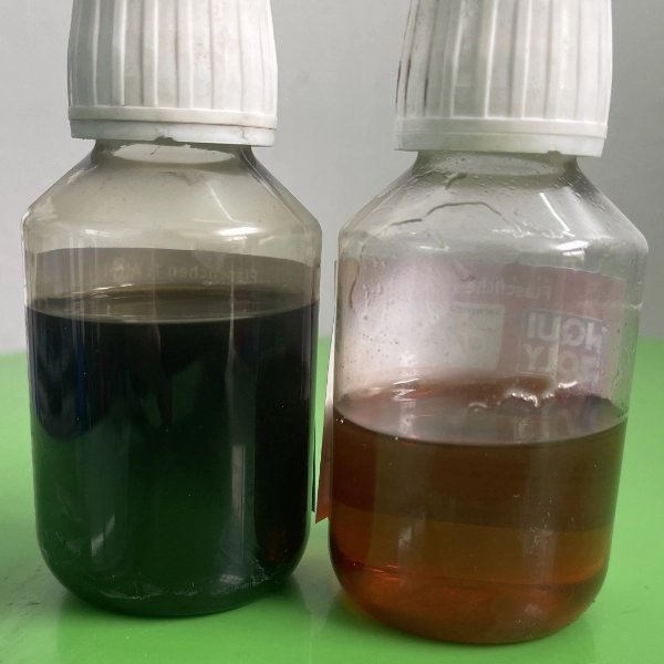 Two transparent plastic bottles with white caps, one filled with dark black liquid and the other with brown liquid, placed on a green surface.