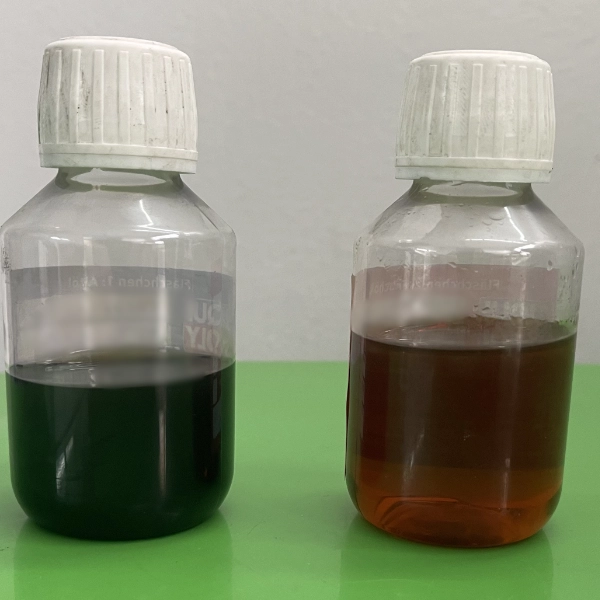 Two small transparent plastic bottles with white caps on a green surface, containing dark liquid on the left and amber liquid on the right.