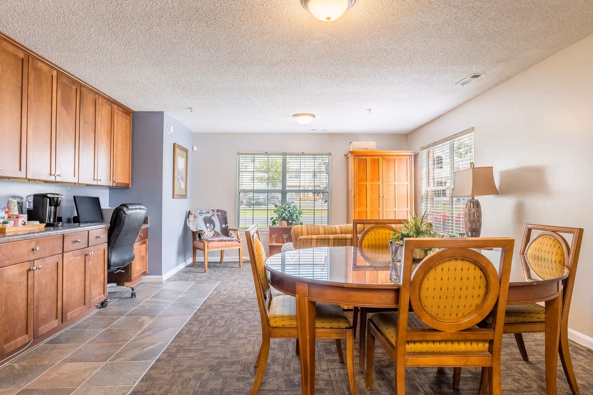 Community room with table, chairs, and des kwith computer