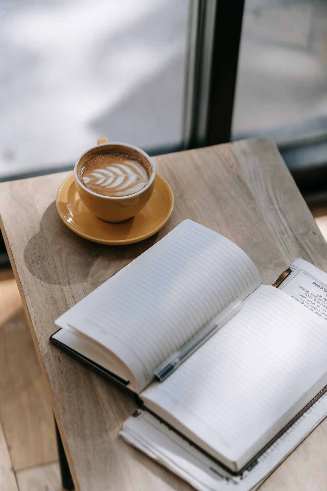 Coffee mug and book on table stock image