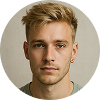 Headshot of a young man with short blonde hair and light facial stubble, wearing a black shirt, on a neutral background.