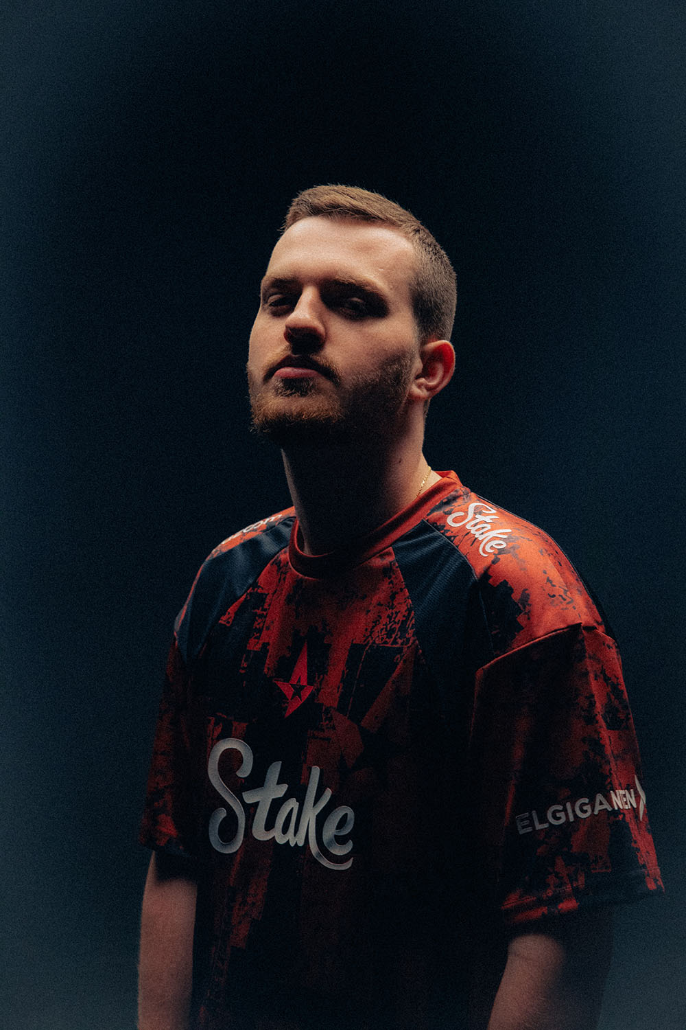 Close-up portrait of Staehr wearing a red and black Astralis jersey.
