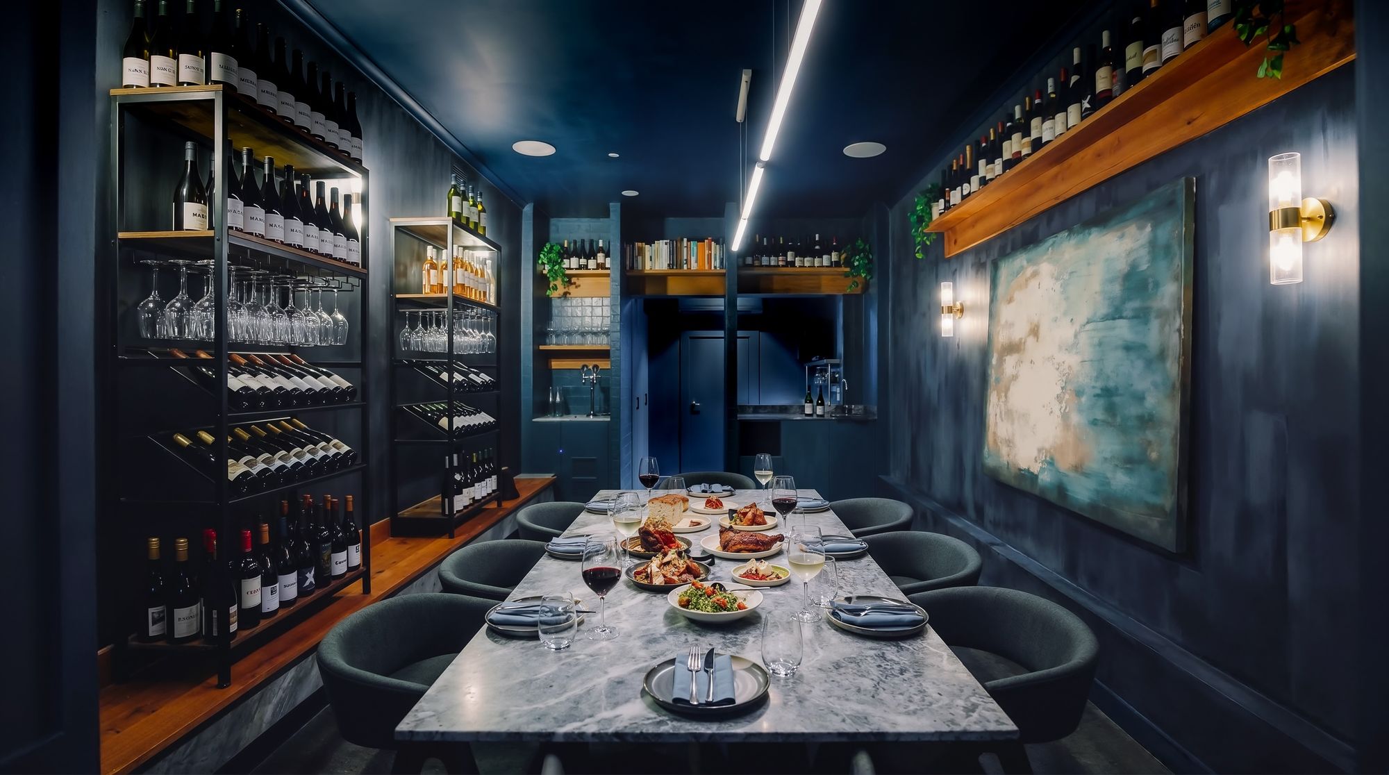 The Maven private dining room in Fitzroy, set for a long shared dinner against a wine wall