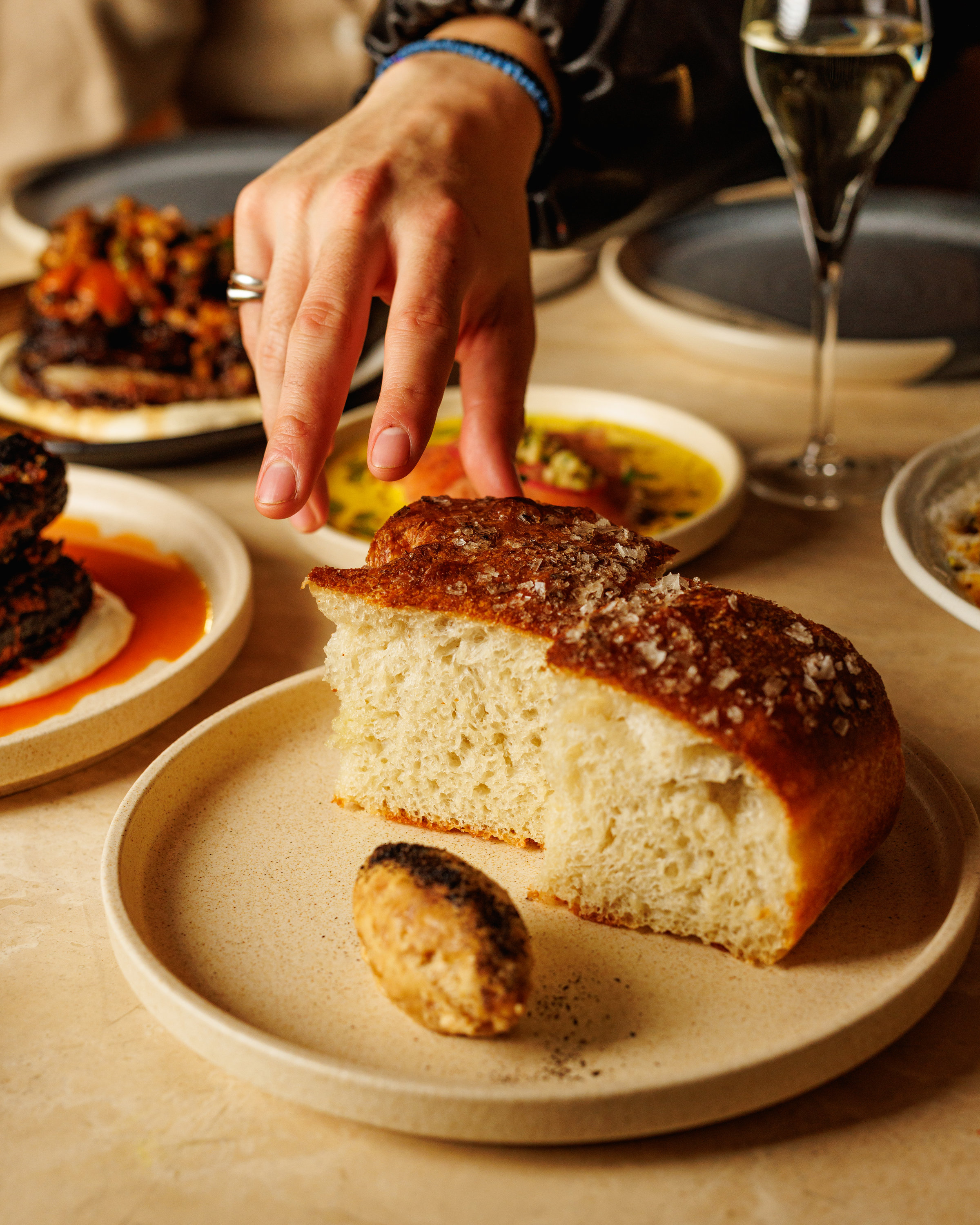 Housemade focaccia torn at the table at Maven in Fitzroy