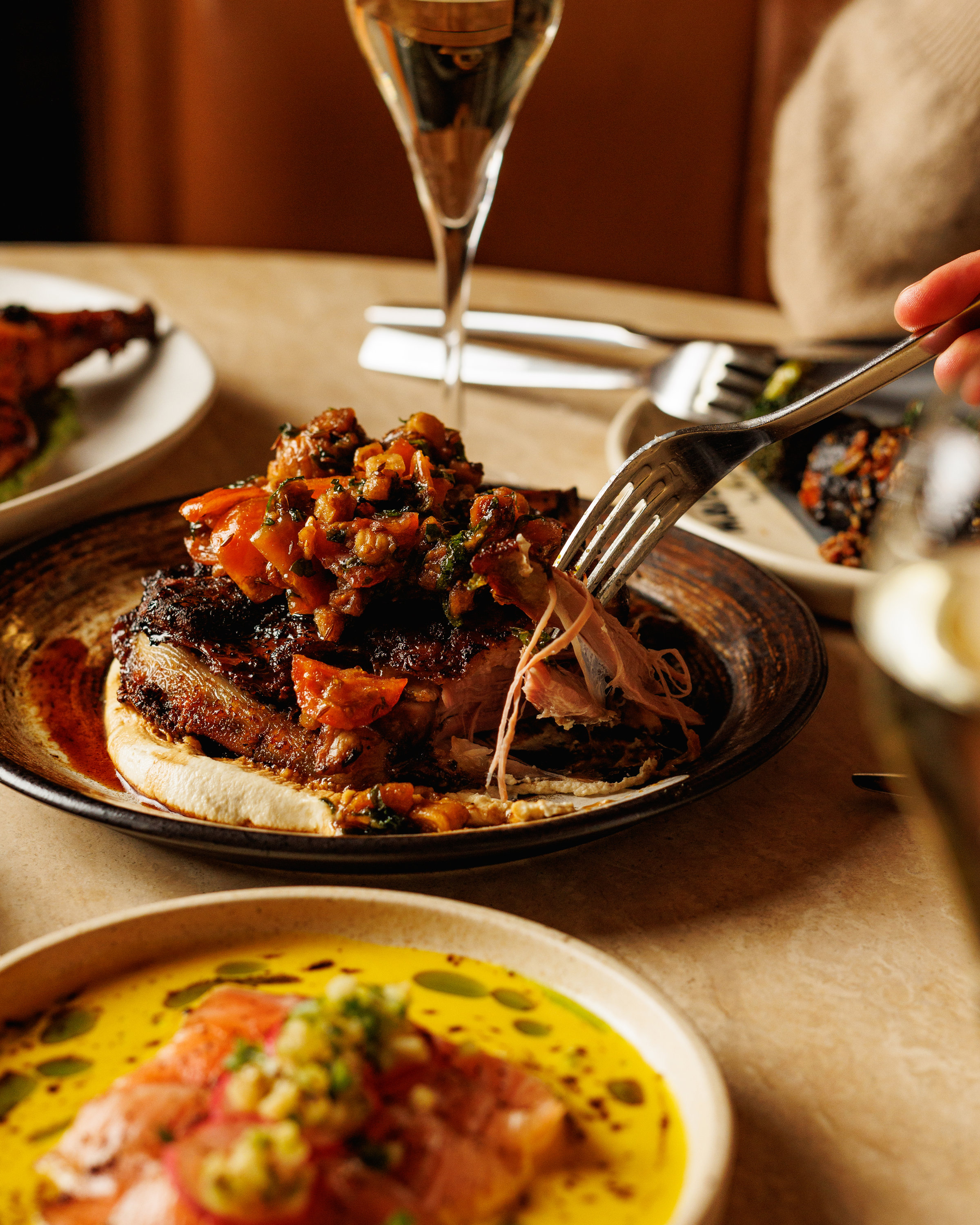 Slow roasted lamb shoulder with charred tomato and figs raheb