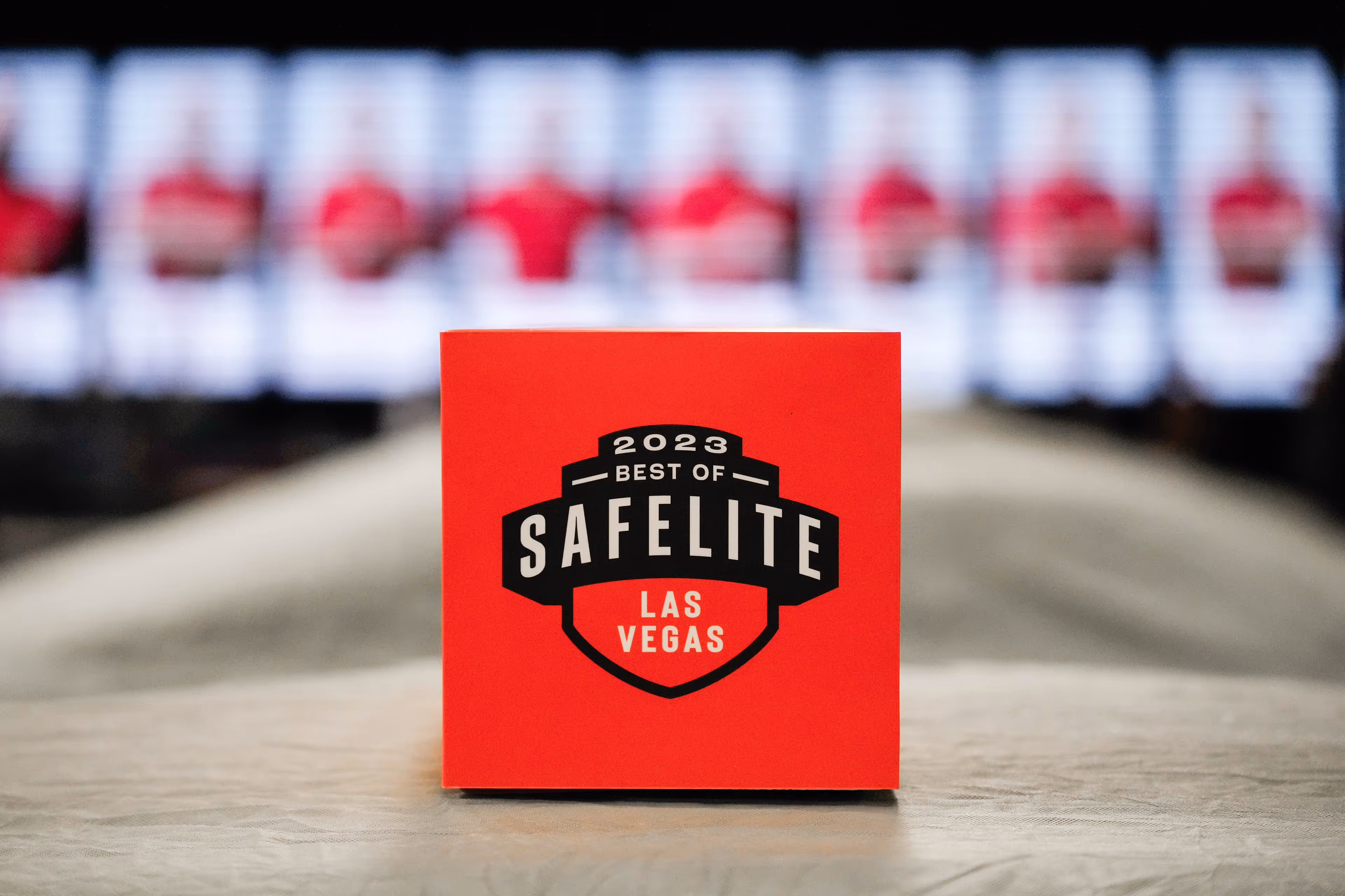 Red award plaque with '2023 Best of Safelite Las Vegas' emblem on a blurred background.