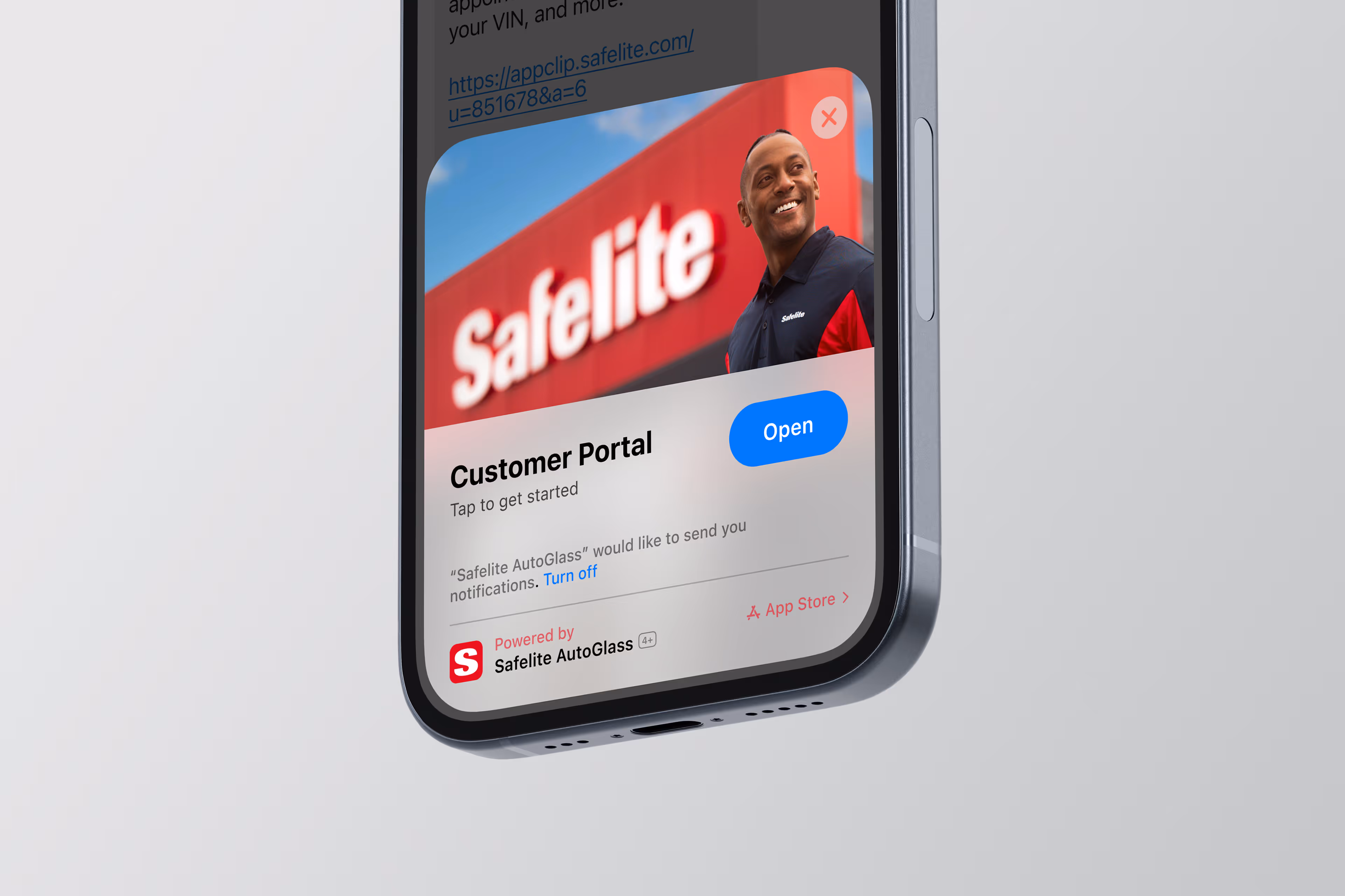 Smartphone screen showing Safelite AutoGlass app clip with an open button and a smiling employee against a Safelite sign background.