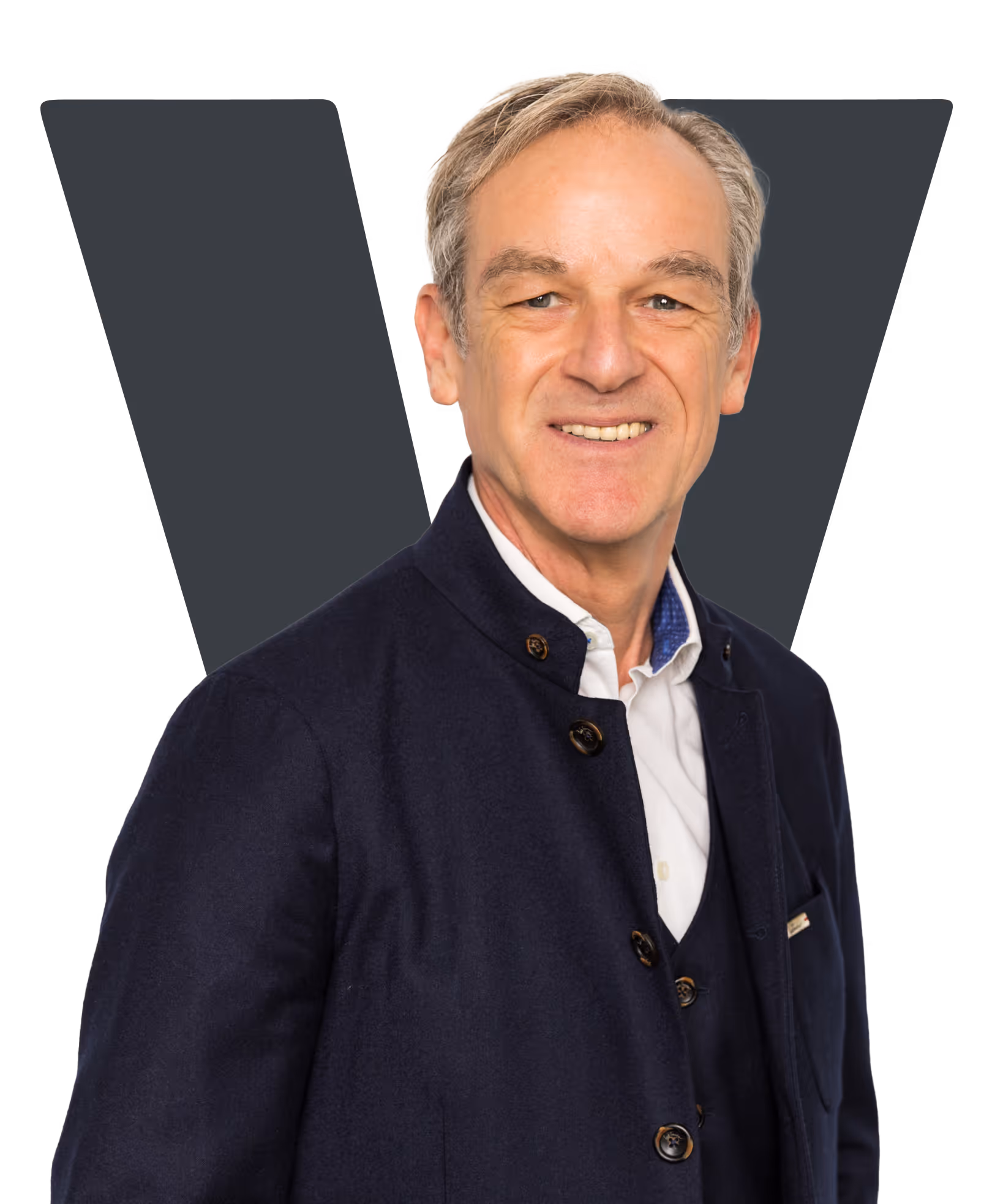 Smiling older man with gray hair wearing a dark buttoned jacket over a white shirt.