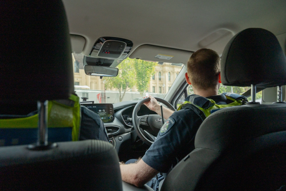 police officer driving a police car 