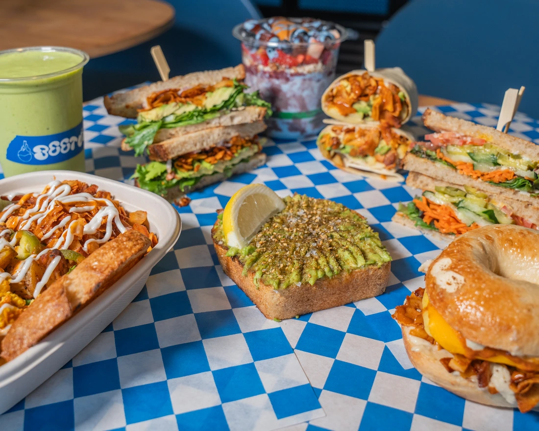 a table full of sandwiches, juices and smoothies