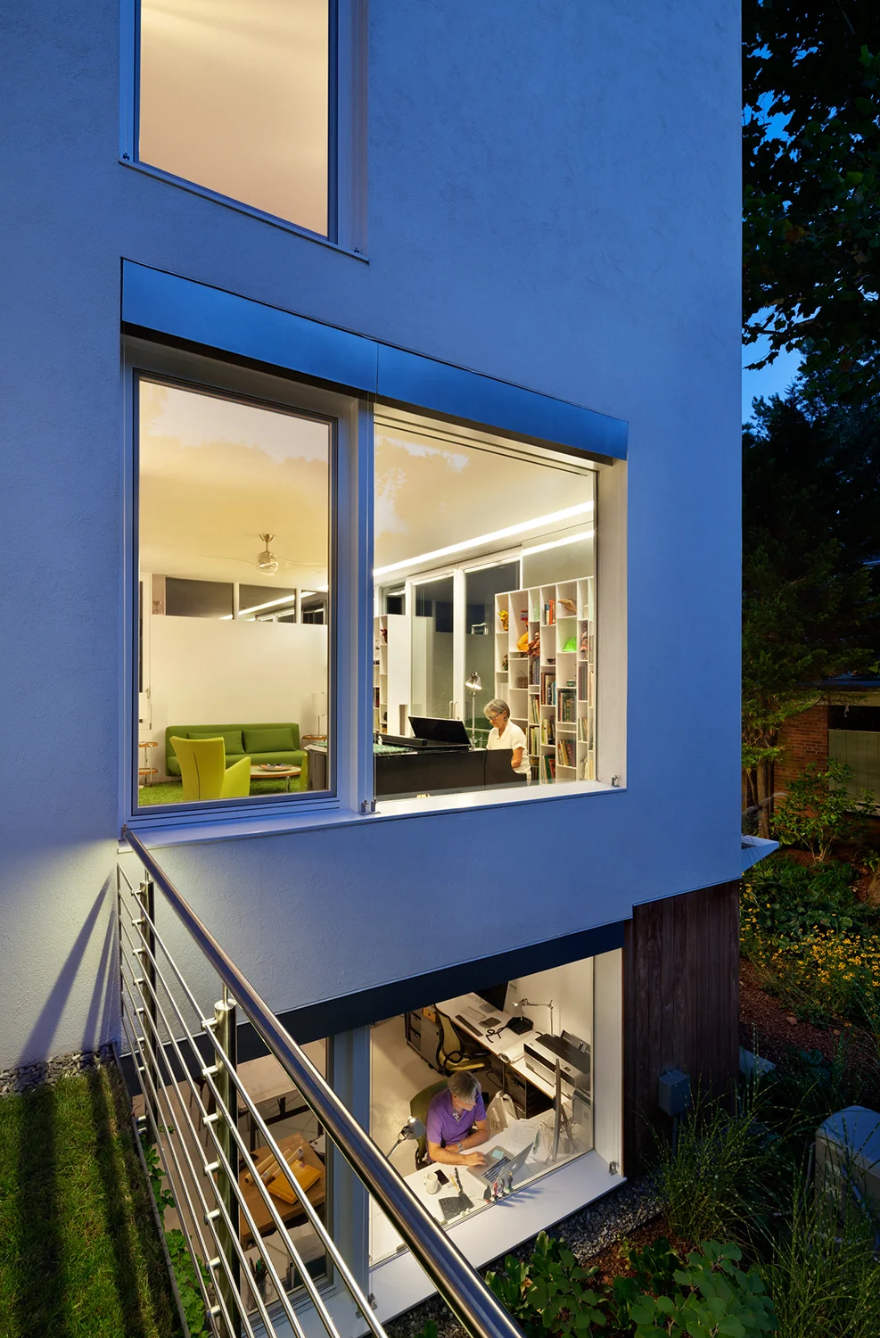 View basement office window, library, and upper bedroom from main floor outdoor courtyard.