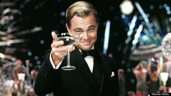 image of Leonardo DiCaprio wearing a tuxedo and raising a glass of champagne for a toast.