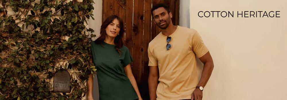 Cotton Heritage catalog image of a man and woman in front of a doorway wearing t-shirts