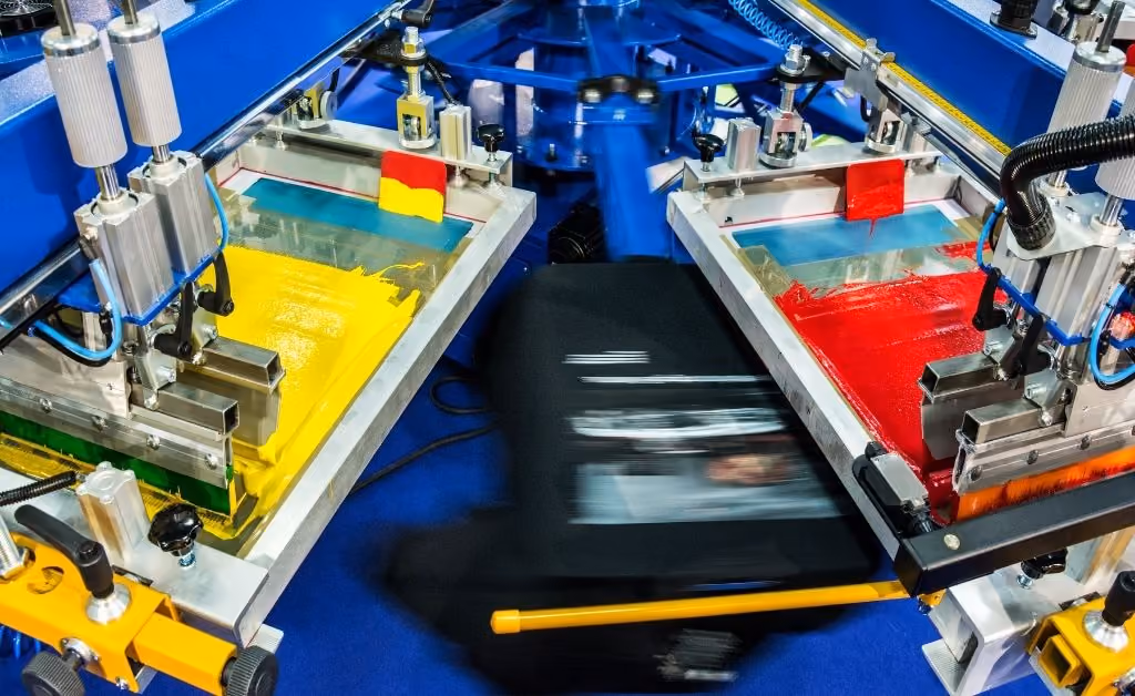 An automatic screen printing press in motion