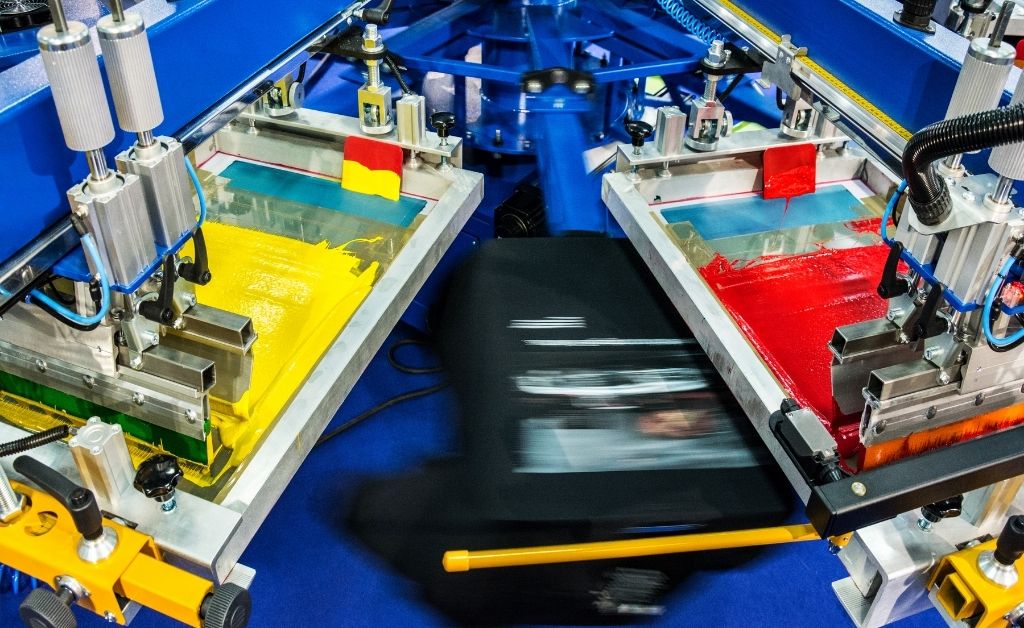 An automatic screen printing press in motion